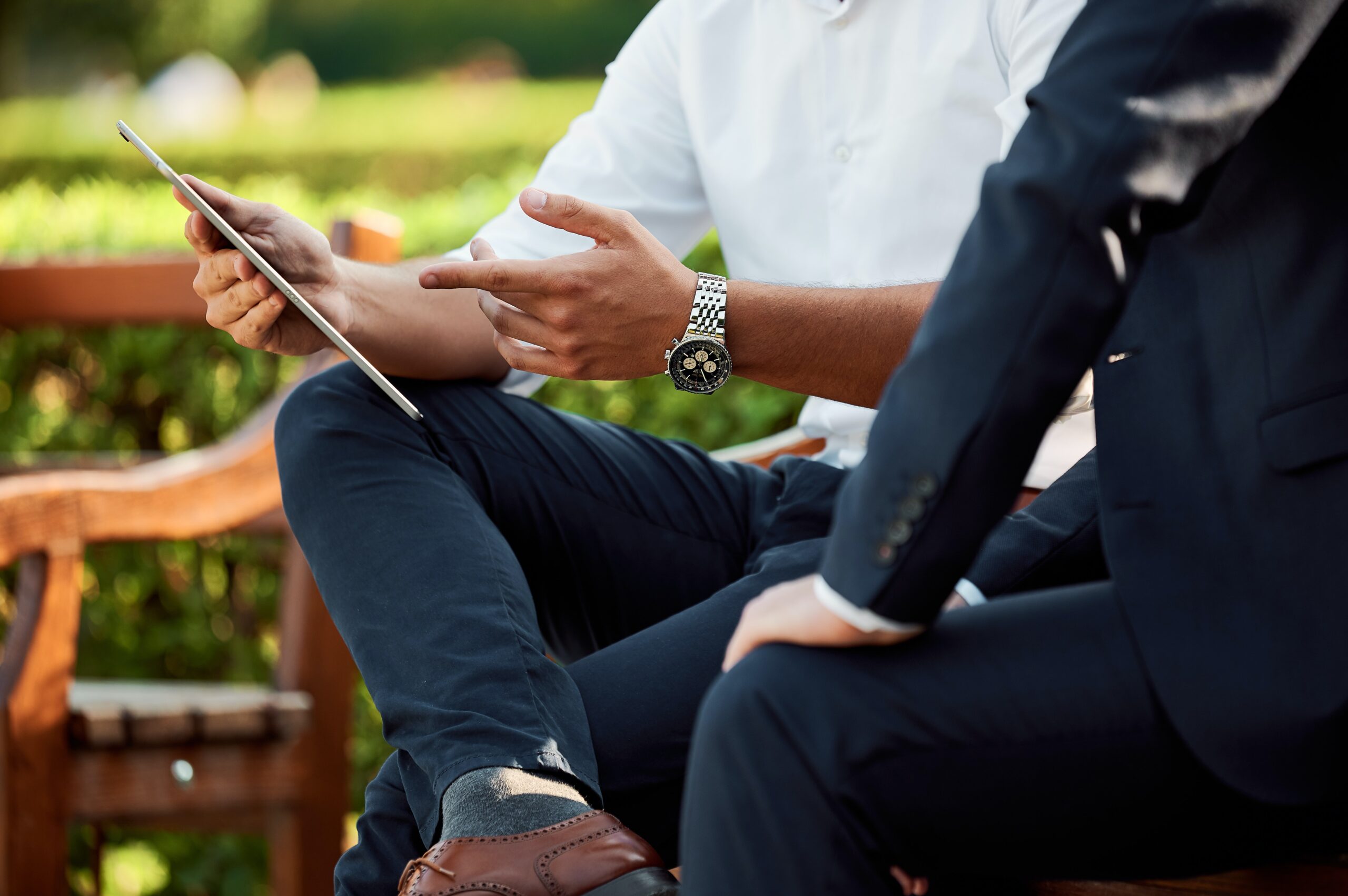 hand pointing at ipad with watch on