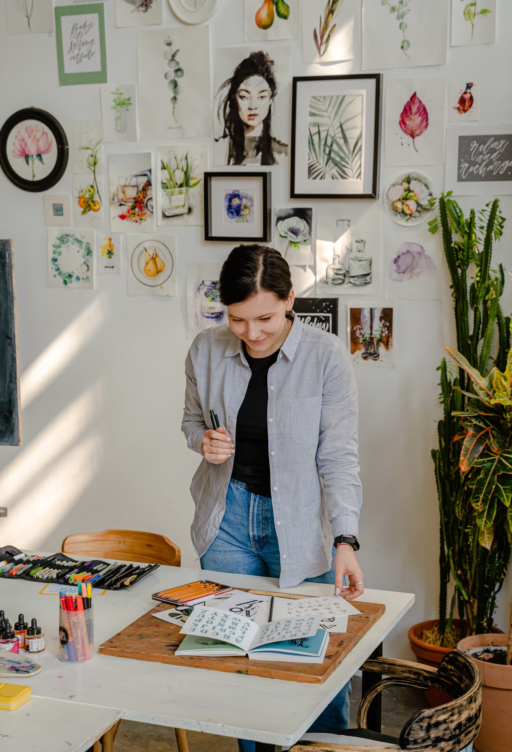 person standing reading with art on walls