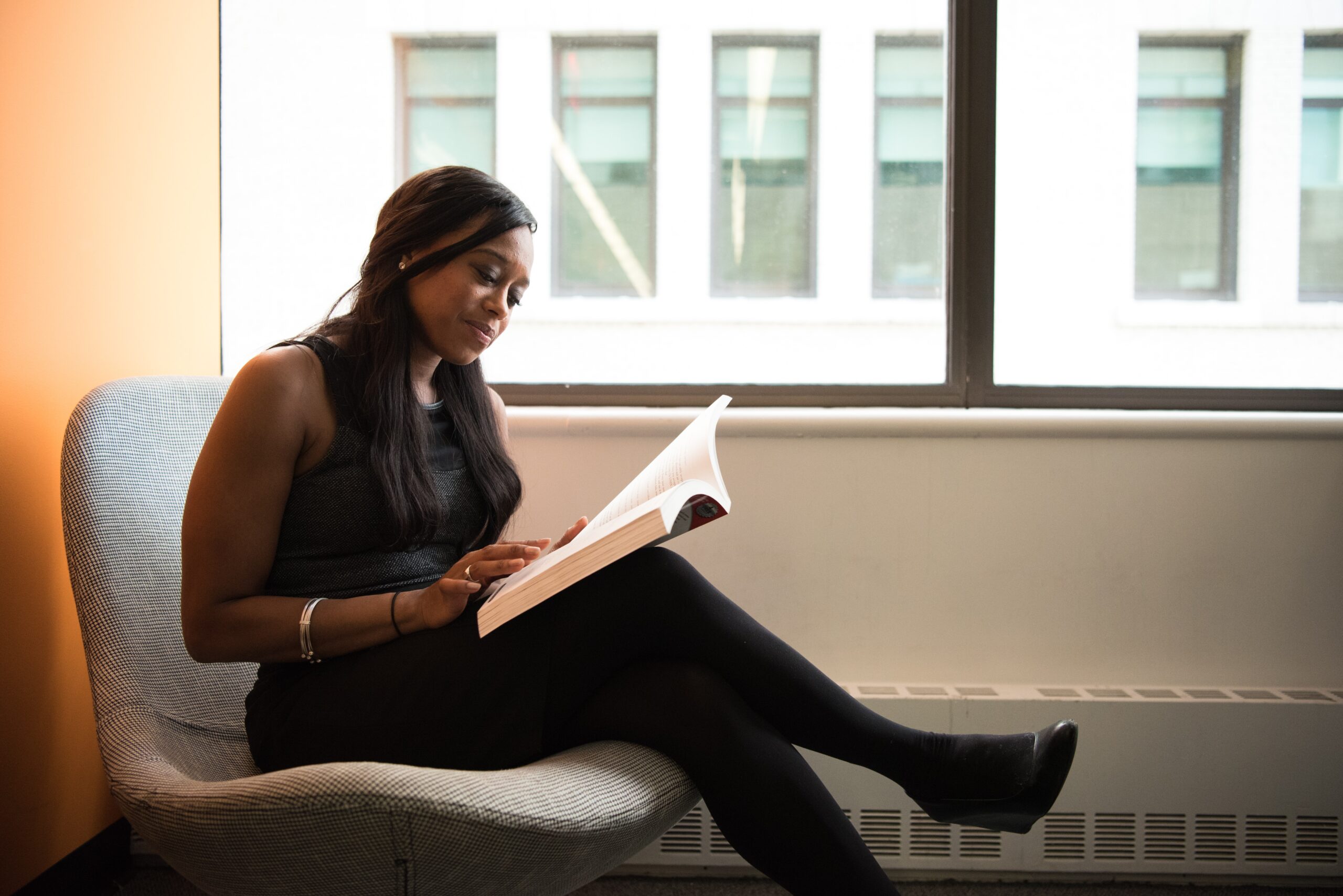 Women sitting on chair reading