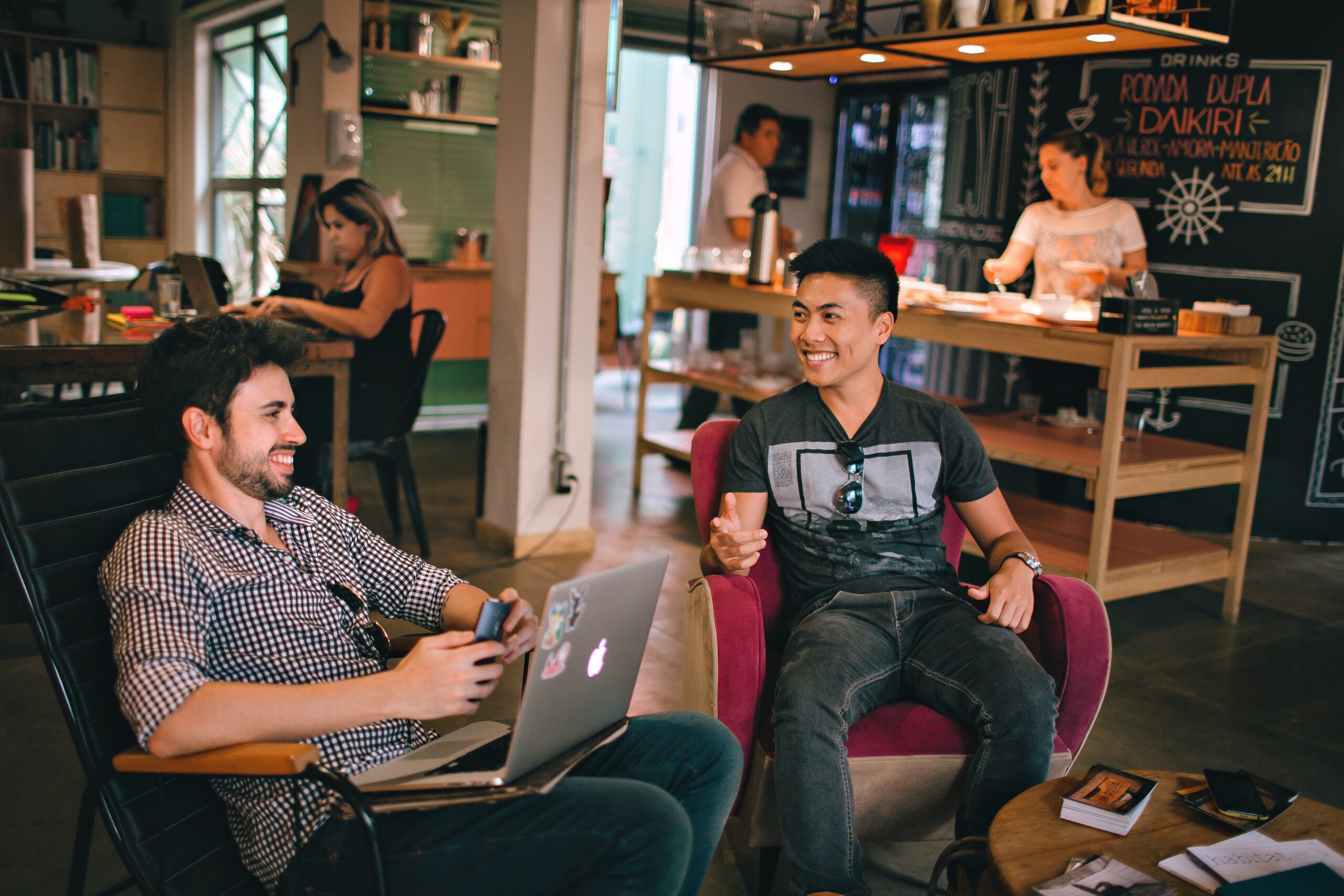 two people smiling in a coffee shop