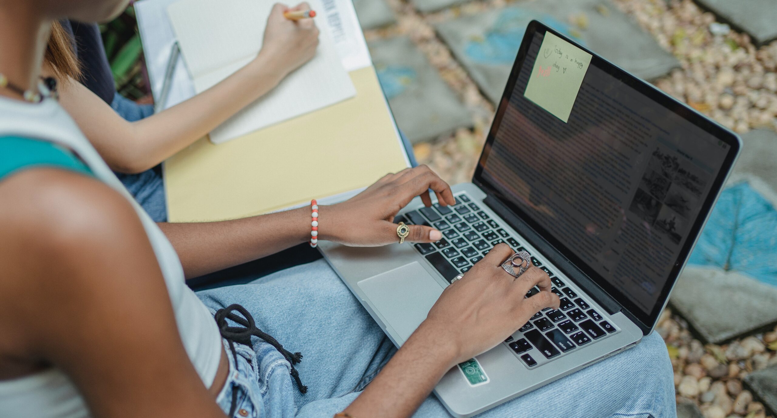 Person sitting with computer on her lap typing