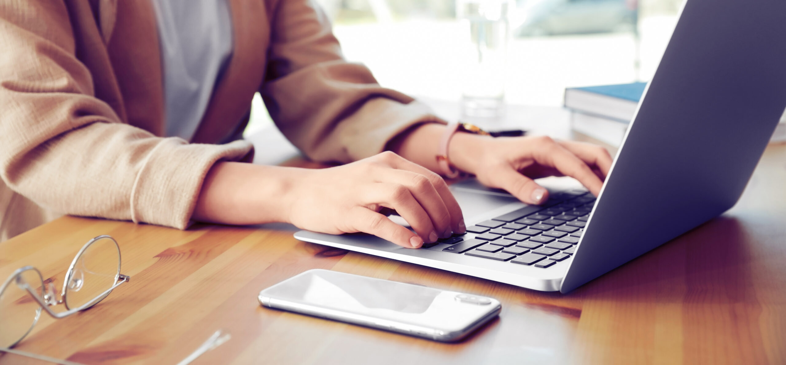 Hands typing on computer