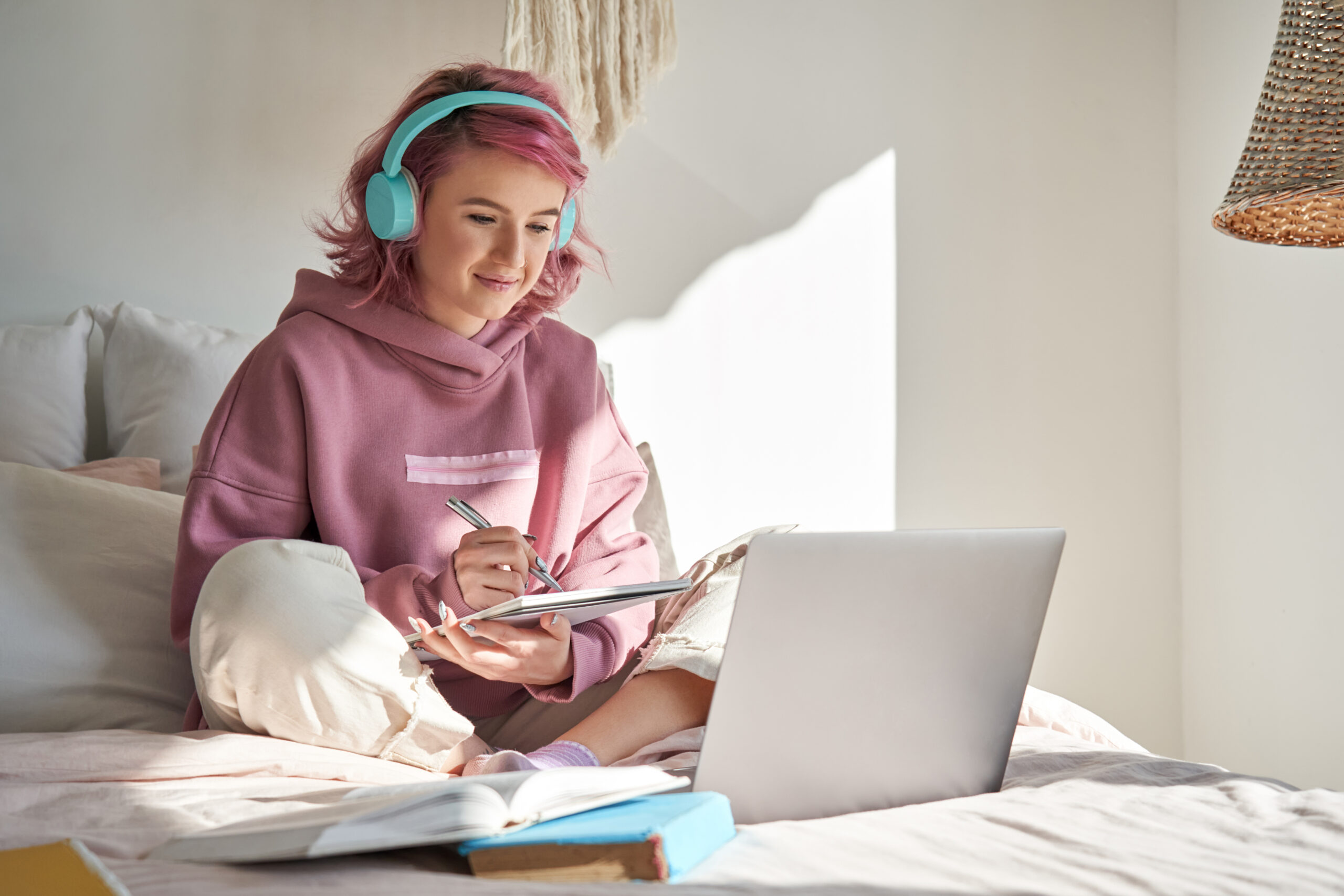 Girl studying on bed with earphones