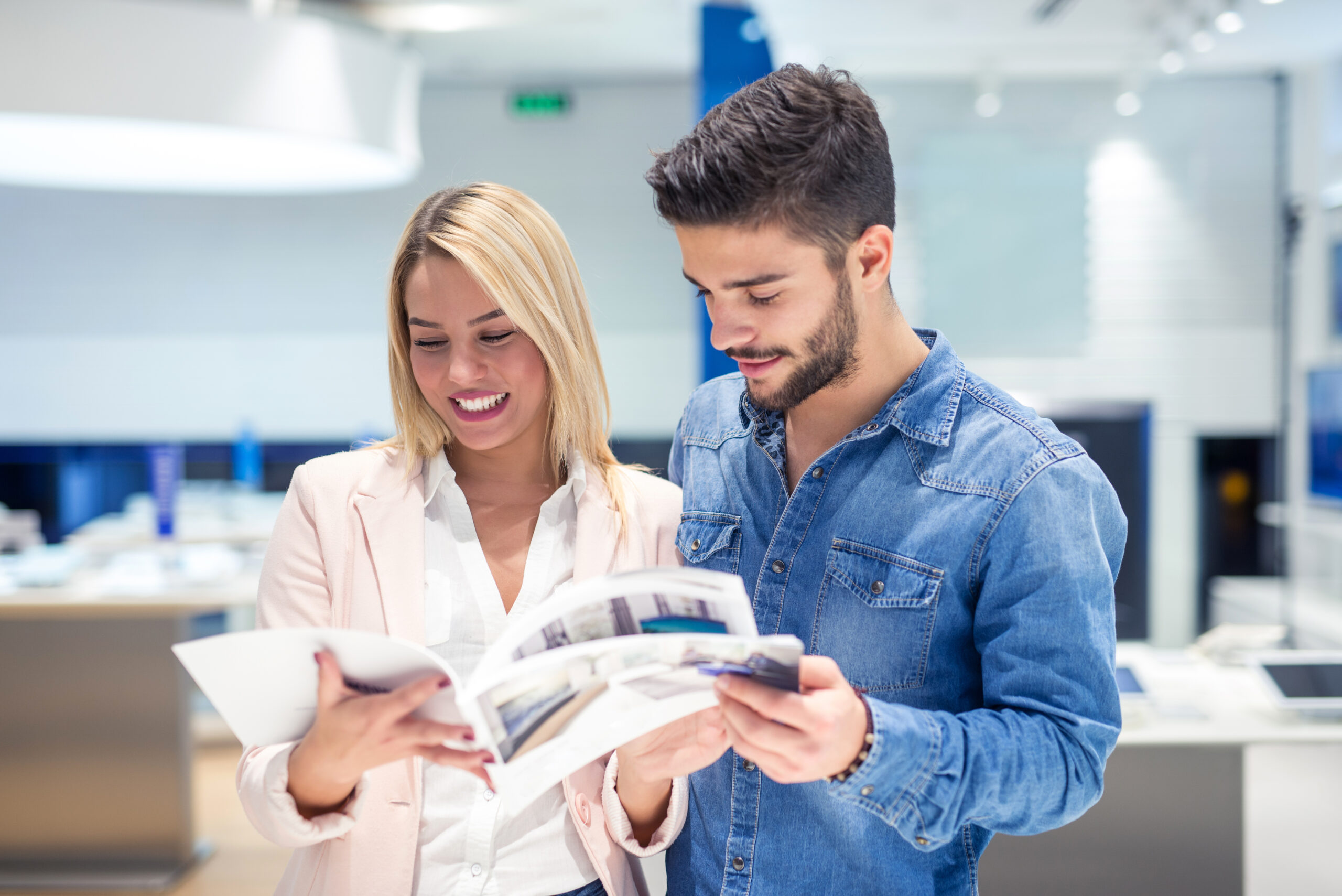 2 happy people reading a catalog