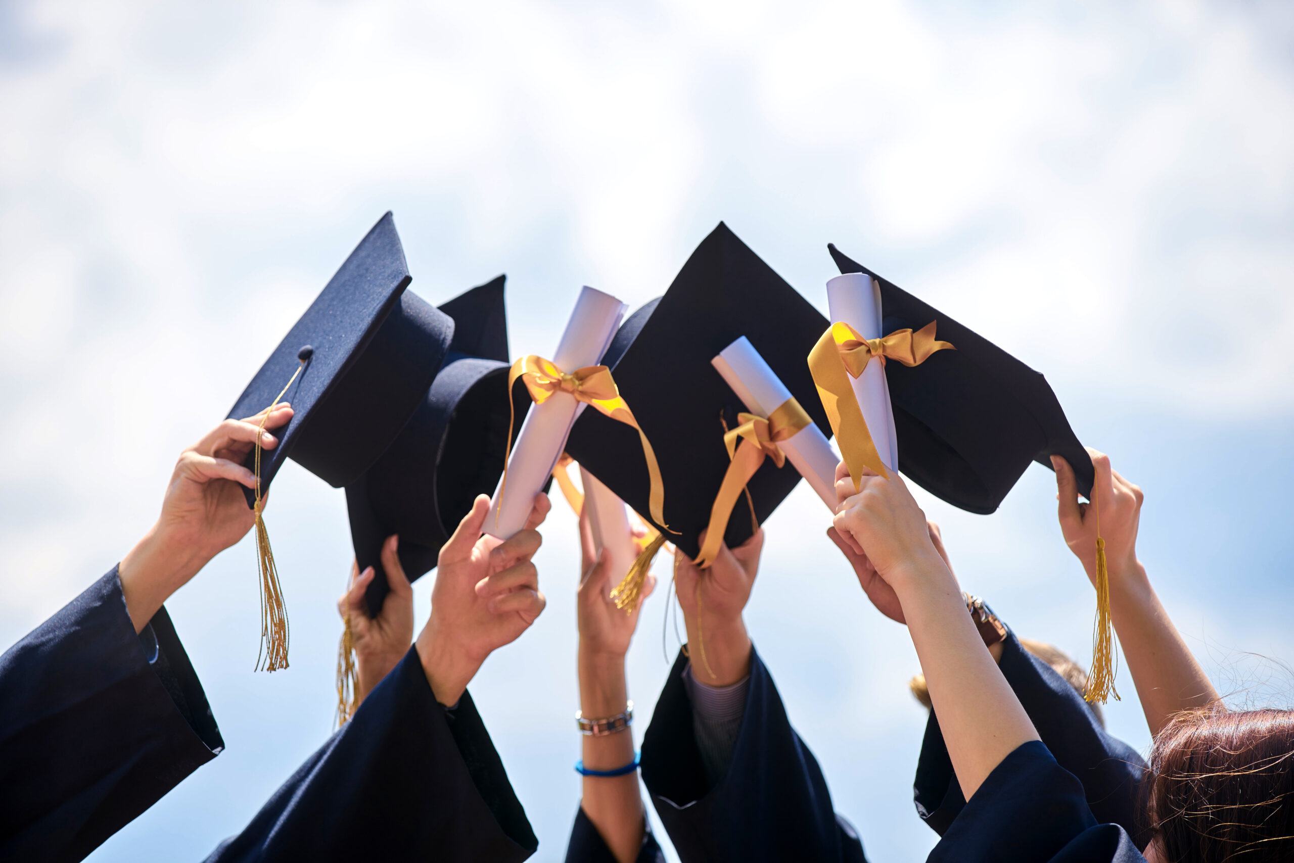 Graduation hats being thrown in the air