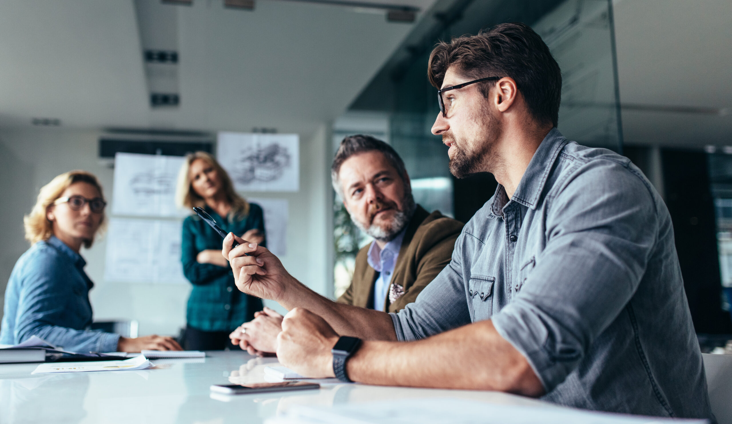 people having a discussion around a table